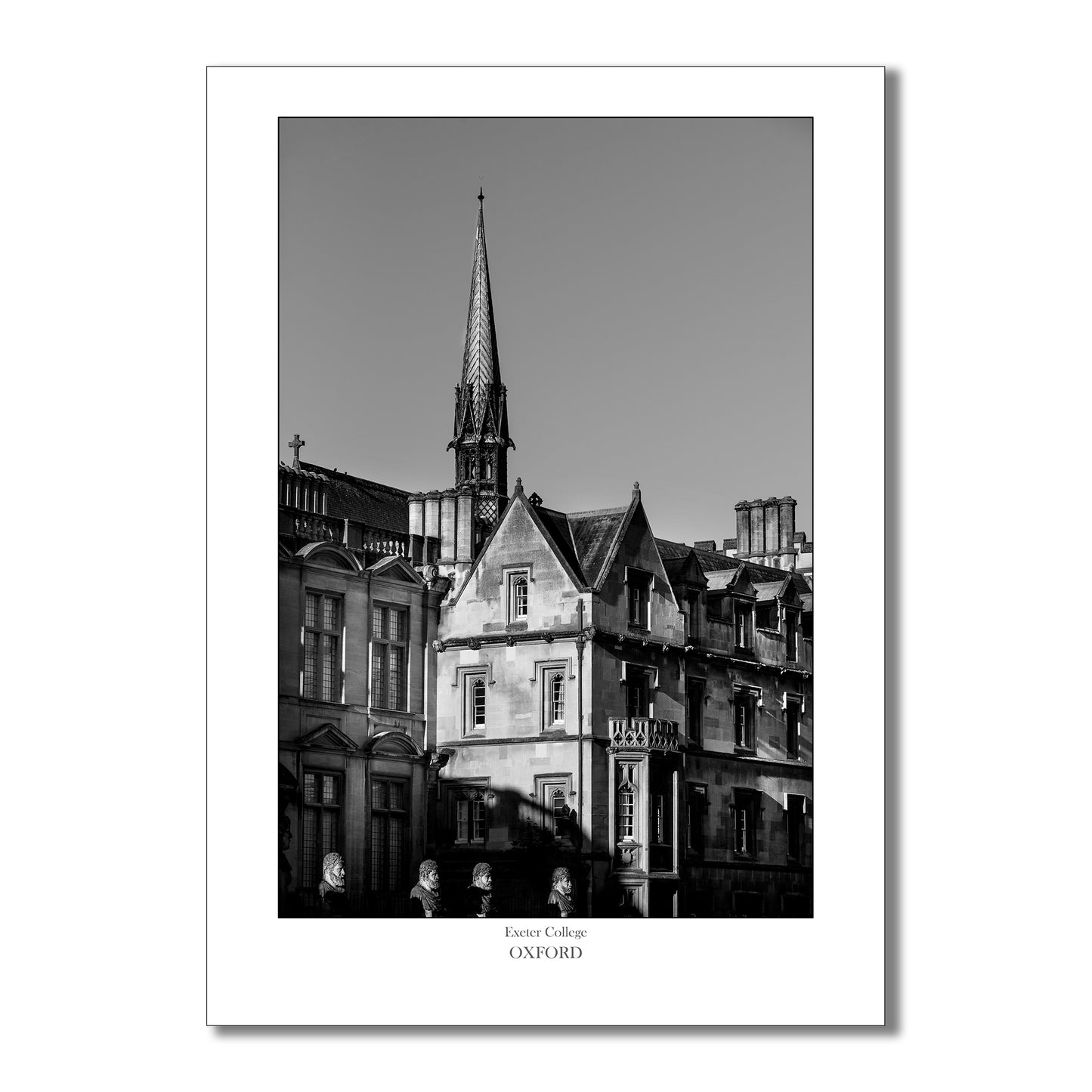 Monochrome art print of Exeter College Chapel tower viewed from Broad Street in Oxford, showcasing intricate Gothic architecture and the historic charm of the city in a striking black-and-white palette.