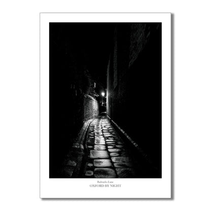 Relive the enchantment of your Oxford visit with this evocative and eerie black and white photographic art print of the narrow cobbles of Bulwarks lane. 