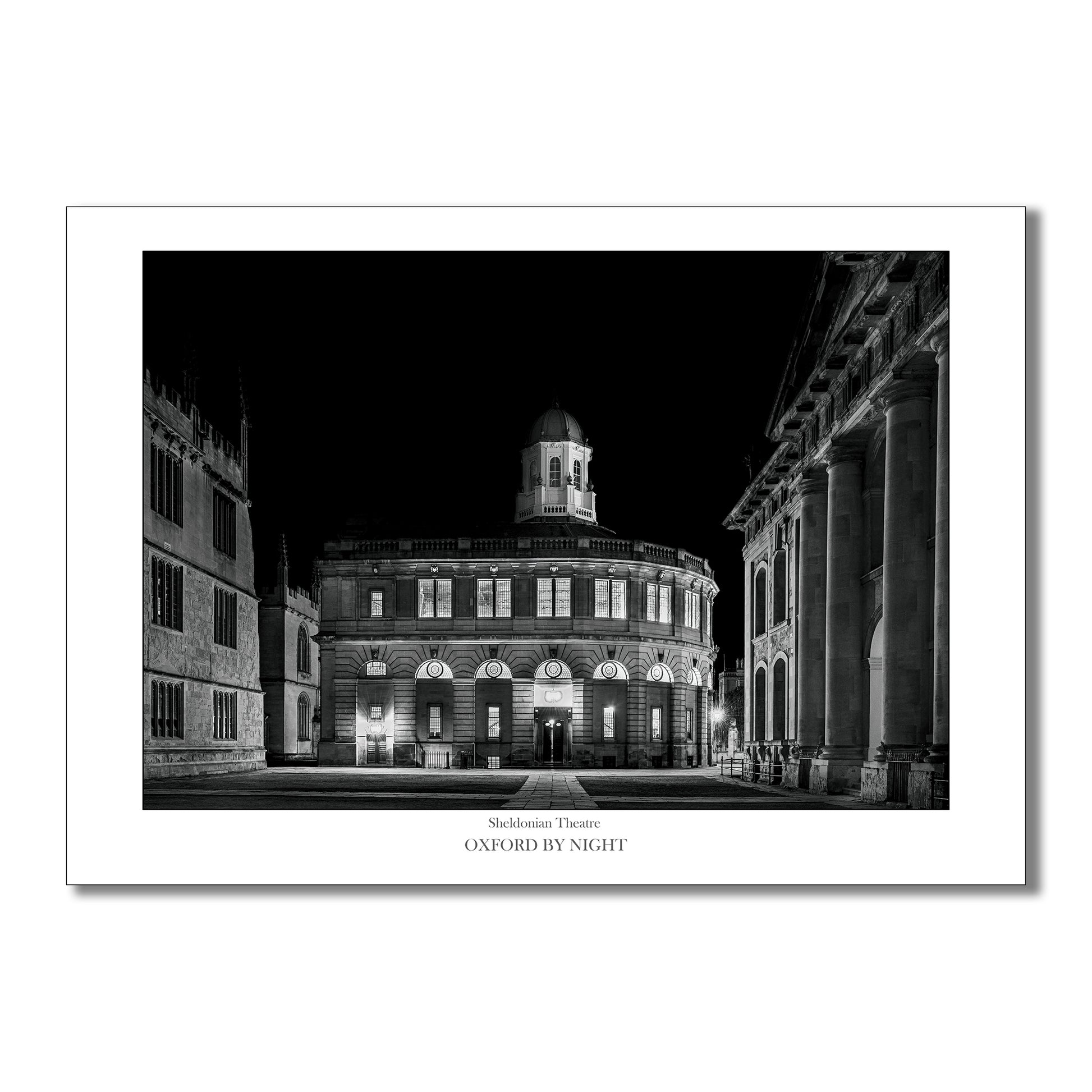 Exclusive B&W art print showcasing The Sheldonian Theatre in Oxford under the cover of darkness. A mesmerizing black and white image highlighting the architectural details of this iconic Oxford Building.