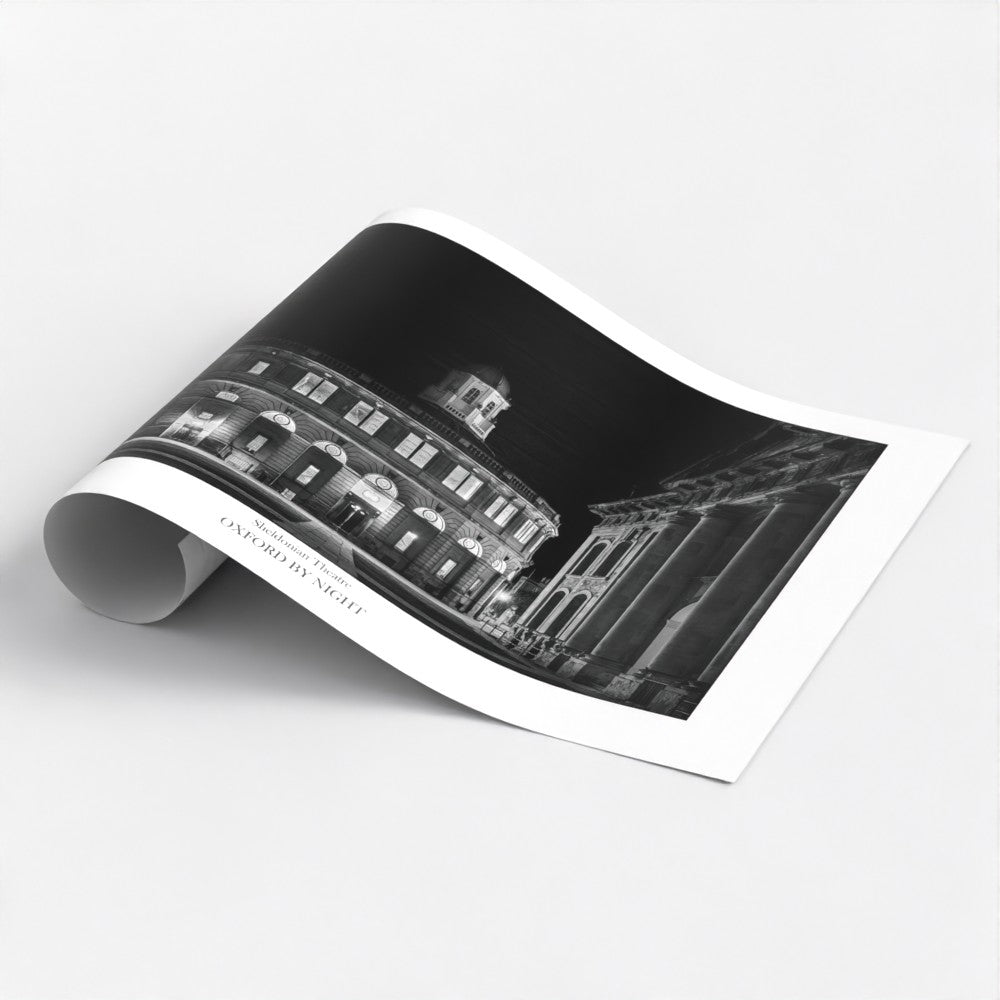 Exclusive B&W art poster print showcasing The Sheldonian Theatre in Oxford under the cover of darkness. A mesmerizing black and white image highlighting the architectural details of this iconic Oxford Building.