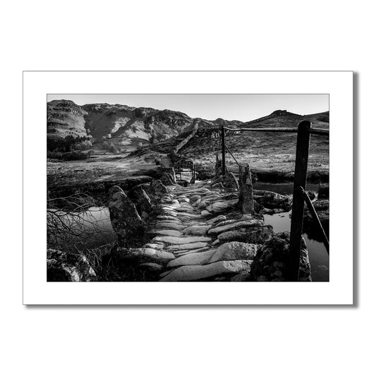 Experience the tactile beauty of the Lake District with this stunning black and white art print of Slaters Bridge. Feel the texture of the cobbles beneath your feet and the serenity of the flowing stream.