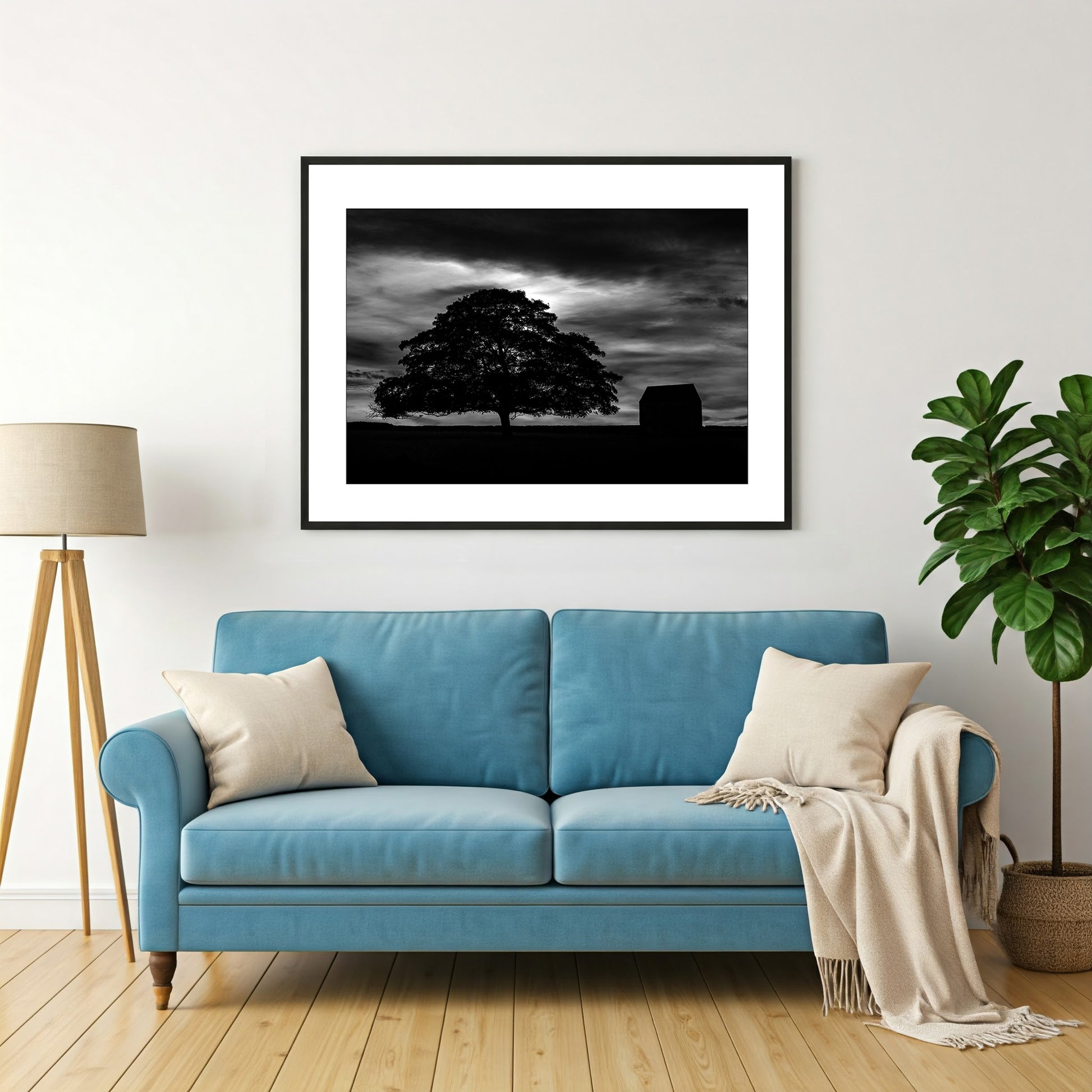 Experience the serenity of the countryside with this captivating black and white wall art print of the silhouette of a tree and barn under a night sky evokes a sense of peace and tranquility