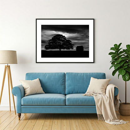 Experience the serenity of the countryside with this captivating black and white wall art print of the silhouette of a tree and barn under a night sky evokes a sense of peace and tranquility