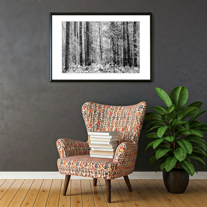 Exclusive monochrome wall art print captures the serene beauty of a winter forest. Tall, snow-dusted trees stand tall against a backdrop of soft, white snow, creating a sense of tranquility and peace